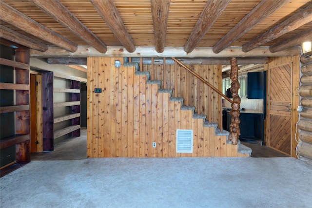 carpeted spare room with rustic walls, wooden ceiling, heating unit, beam ceiling, and a notable chandelier