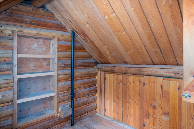 interior space with a wood stove, a wealth of natural light, stairway, and hardwood / wood-style floors