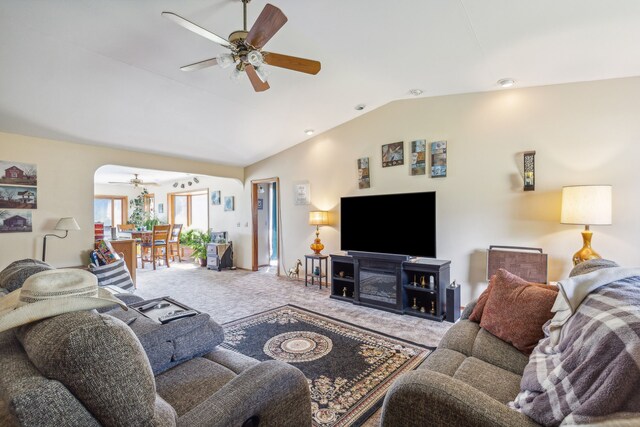 living room featuring carpet floors, ceiling fan, and lofted ceiling