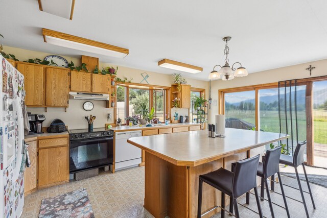 kitchen with a notable chandelier, black electric range, decorative light fixtures, dishwasher, and light tile patterned floors