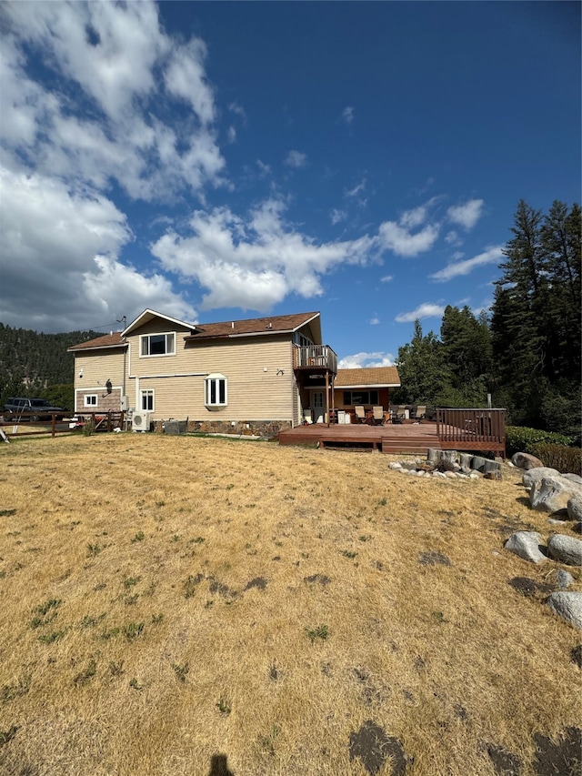 exterior space featuring a deck and a lawn