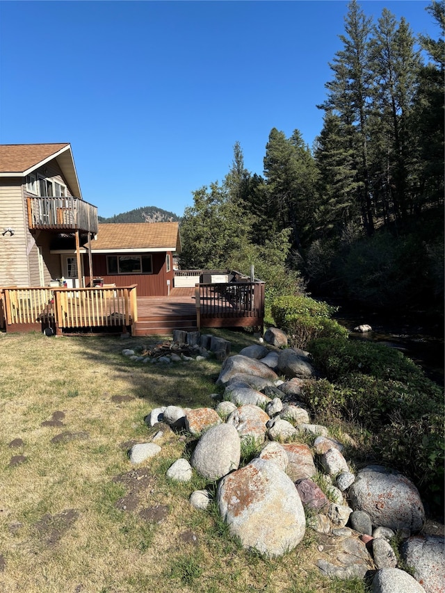 view of yard featuring a wooden deck