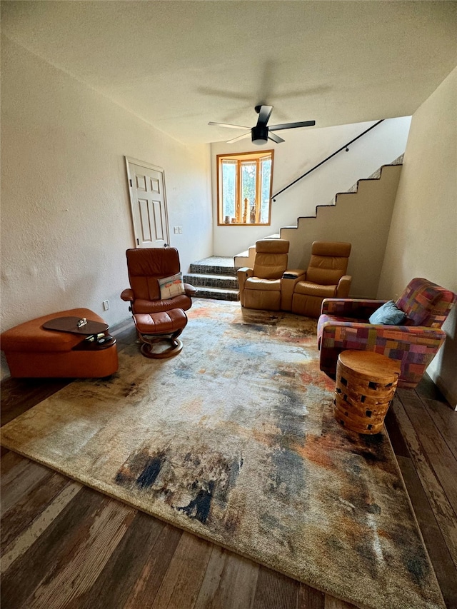 living room featuring wood-type flooring and ceiling fan