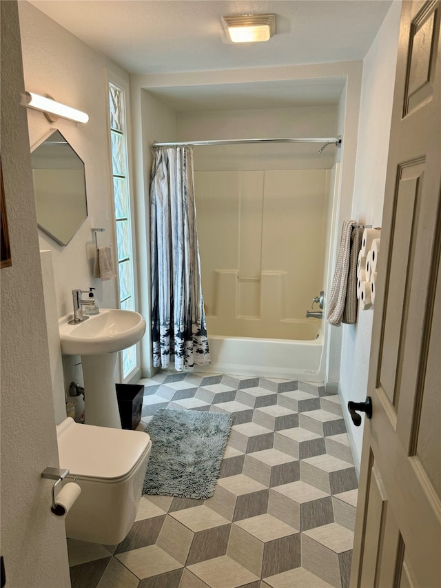 bathroom featuring toilet, tile patterned flooring, and shower / bath combo with shower curtain