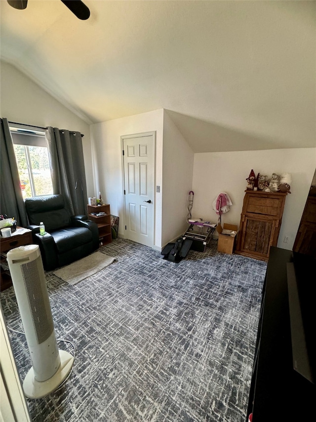 carpeted living room with lofted ceiling and ceiling fan