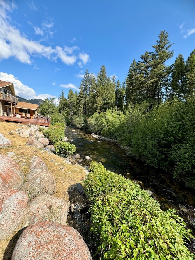 view of yard featuring a deck with water view