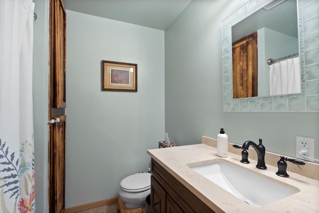 bathroom featuring toilet and vanity