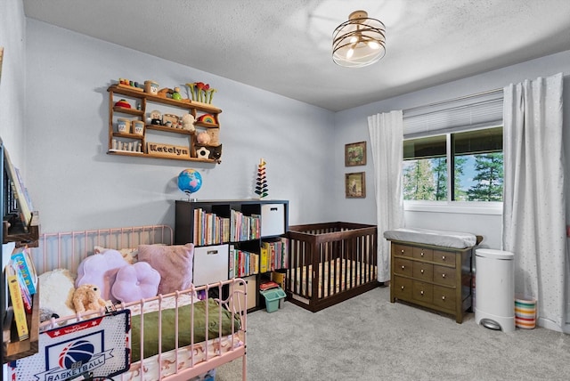 bedroom with a textured ceiling and light colored carpet