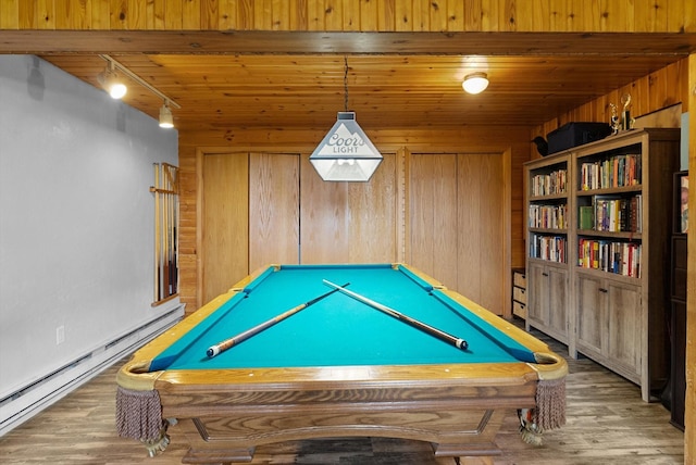 playroom with pool table, rail lighting, baseboard heating, wood walls, and wood finished floors