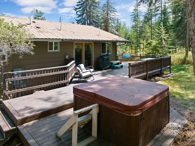 wooden terrace featuring a hot tub