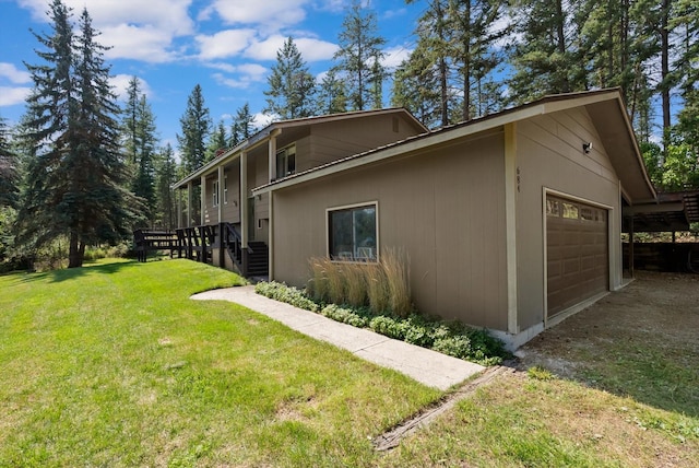 view of side of property featuring a lawn and an attached garage