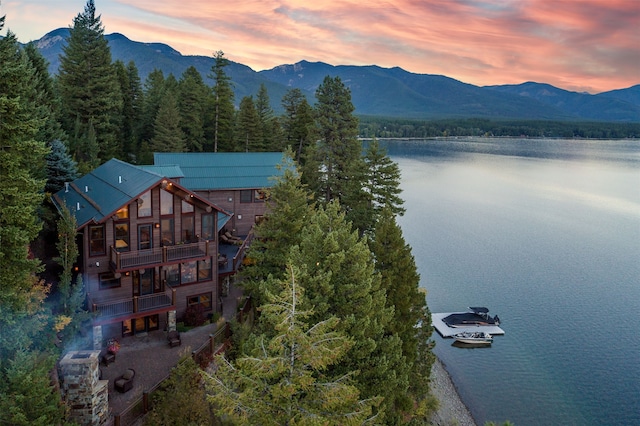 aerial view at dusk with a water and mountain view