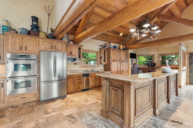 kitchen featuring a sink, stone tile floors, appliances with stainless steel finishes, wooden ceiling, and light stone countertops