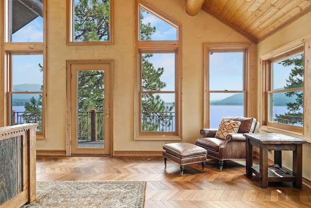 interior space featuring vaulted ceiling, plenty of natural light, and a water view