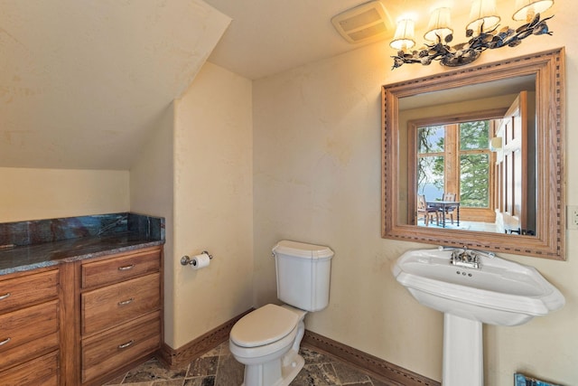 half bath with lofted ceiling, toilet, baseboards, and visible vents