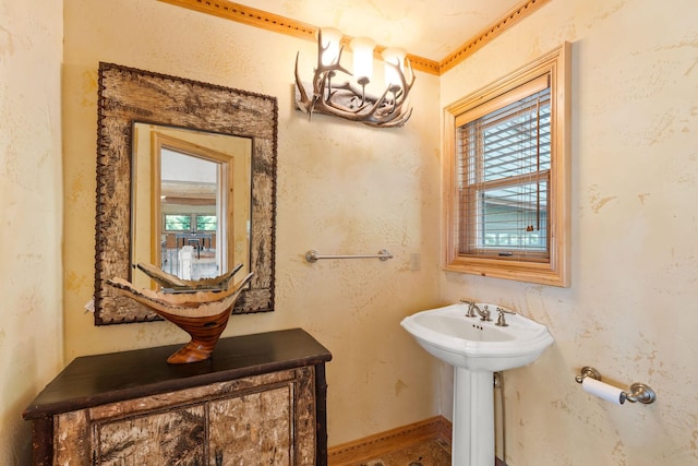 half bathroom featuring baseboards and a textured wall