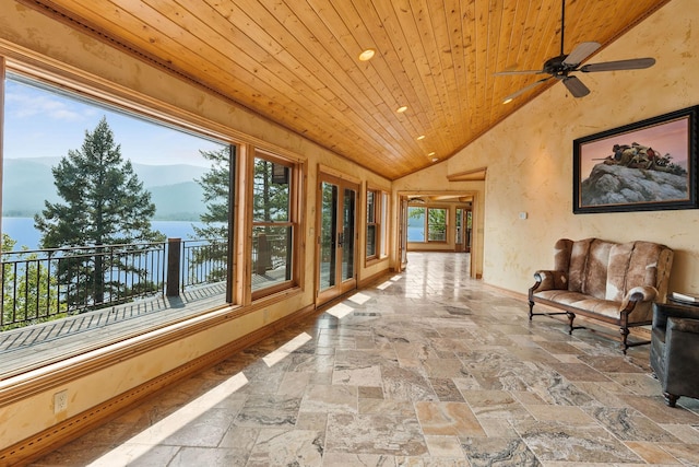 hallway with a wealth of natural light, recessed lighting, wood ceiling, and stone tile flooring