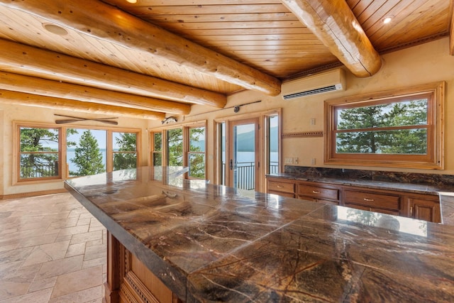 kitchen featuring a wealth of natural light, wooden ceiling, and a wall mounted AC