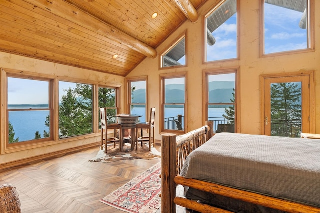 bedroom featuring beam ceiling, multiple windows, a water view, and wooden ceiling