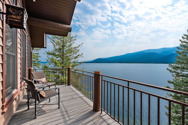 balcony with a water and mountain view