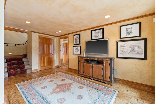 living room with stairway, recessed lighting, wood-type flooring, and ornamental molding