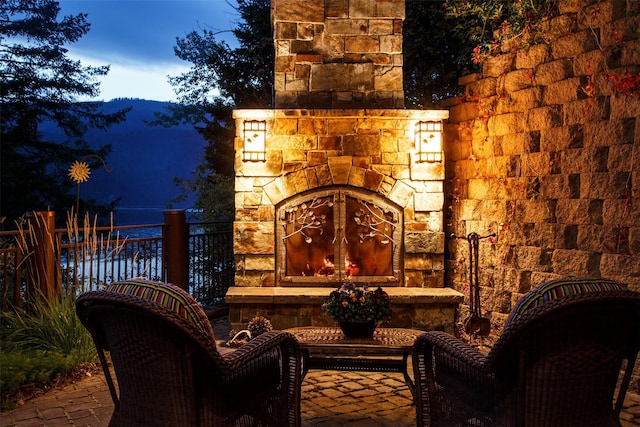 exterior space with fence and an outdoor stone fireplace