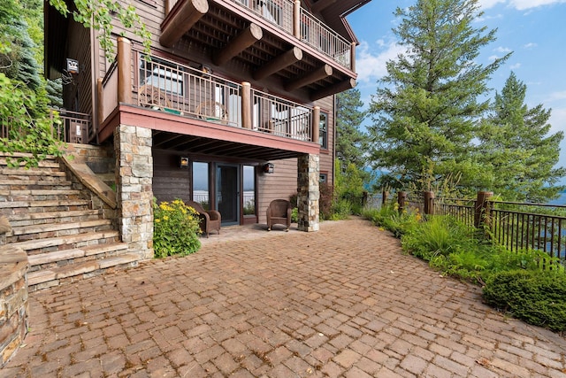 view of patio / terrace with stairway and fence