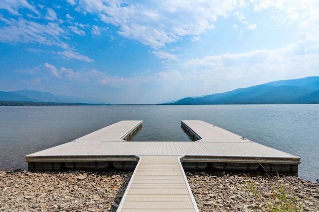 view of dock featuring a water and mountain view