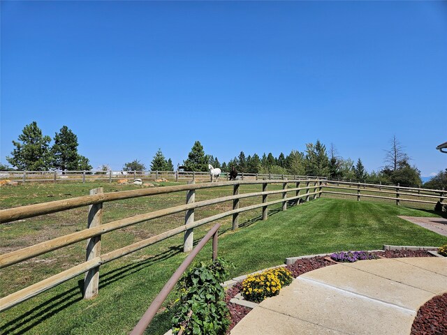 view of yard with a rural view and fence