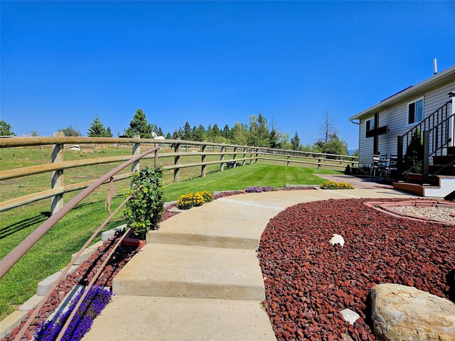 view of yard with a patio area, a rural view, and fence