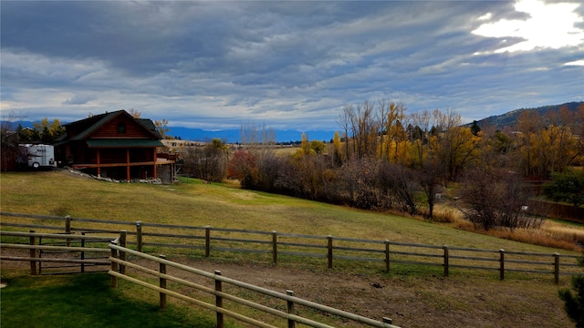 view of yard with a rural view and fence