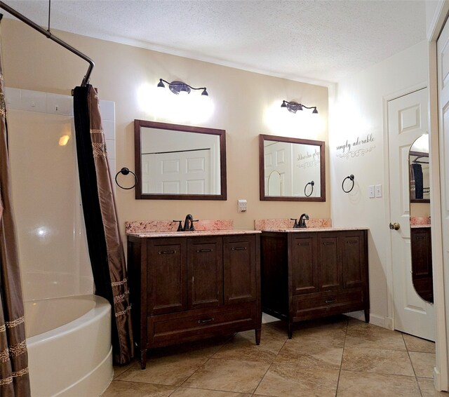 full bathroom with tile patterned flooring, a textured ceiling, vanity, and shower / bathtub combination with curtain