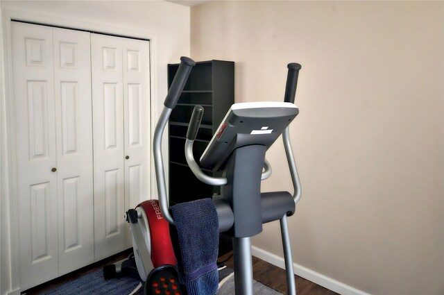 workout room with wood finished floors and baseboards