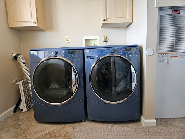 washroom featuring light tile patterned floors, washing machine and dryer, a heating unit, and baseboards