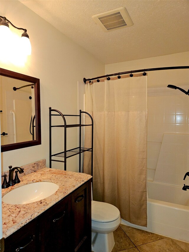 full bath with vanity, visible vents, a textured ceiling, tile patterned floors, and toilet