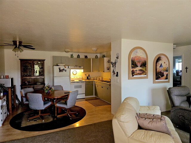 dining room with light wood-type flooring and ceiling fan