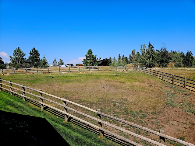 view of yard featuring a rural view and fence