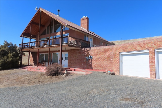 rear view of property with a garage