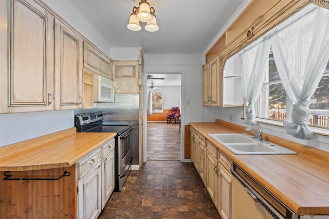 kitchen with appliances with stainless steel finishes, light brown cabinetry, ornamental molding, and sink