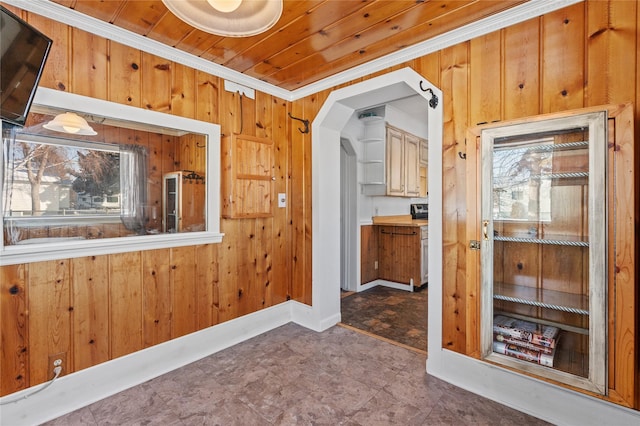 interior space featuring wood walls, crown molding, and wood ceiling