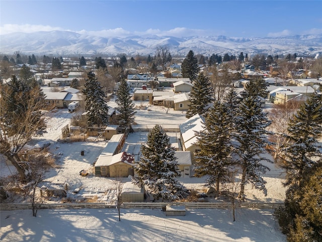 snowy aerial view featuring a mountain view