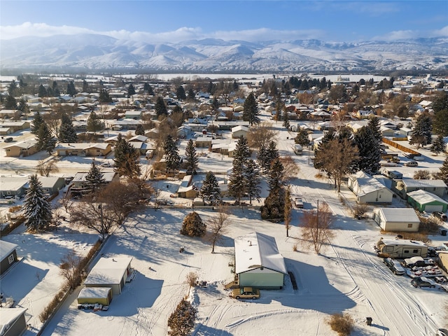 snowy aerial view with a mountain view