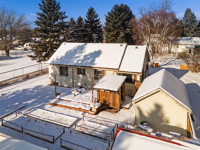 view of snow covered back of property