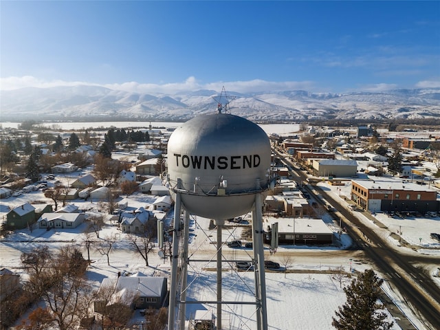 snowy aerial view with a mountain view