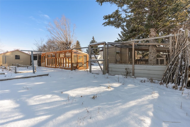 yard covered in snow featuring an outbuilding