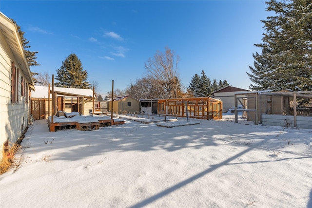 yard covered in snow featuring a deck