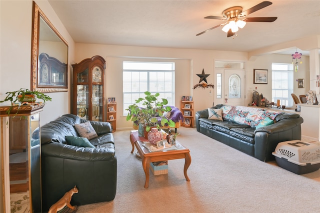 living room with carpet floors, ceiling fan, and a healthy amount of sunlight