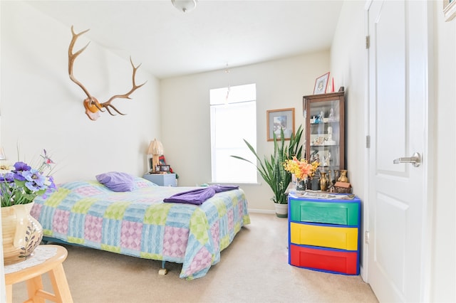 bedroom featuring light carpet