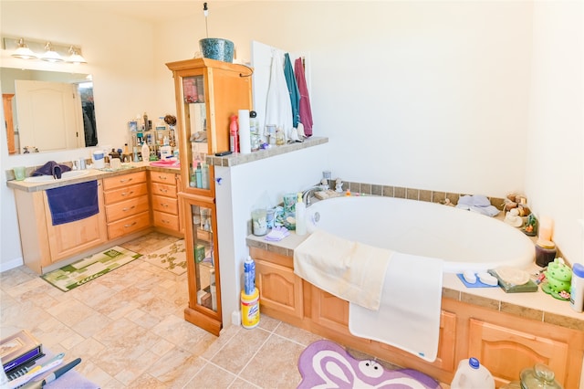 bathroom with tile patterned floors, vanity, and a tub to relax in