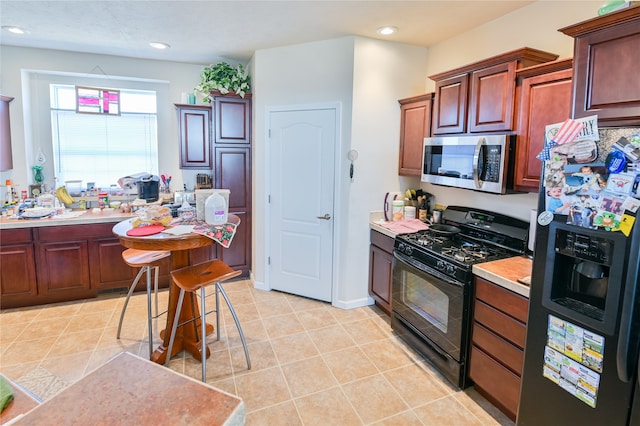 kitchen featuring light tile patterned flooring and stainless steel appliances